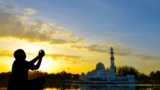 Generic -- Stock Photo: muslim kid prayed during sunset Image ID:261167027 Copyright: badins