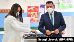 The leader of SDSM, Macedonia's ruling party, Zoran Zaev, and his wife, Zorica, vote at a polling station in the city of Strumica on July 15.