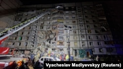 Emergency personnel work at the scene of the Russian strike on Kharkiv on October 30. 