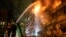 Ukrainian firefighters work at the site of an apartment building damaged by a Russian missile strike late on October 13.