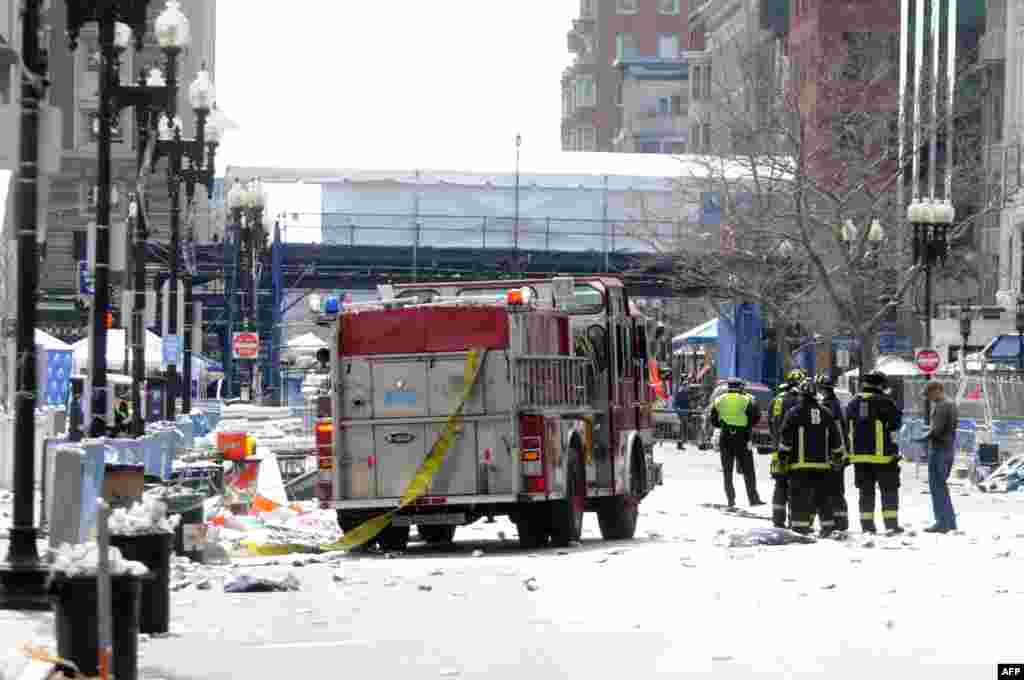 Firefighters take up a position on Boyltson Street, near the finish line, after the two bombs exploded.