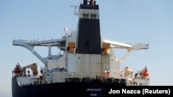 An Iranian flag flies on Iranian oil tanker Adrian Darya 1, previously named Grace 1, as it sits anchored after the Supreme Court of the British territory lifted its detention order, in the Strait of Gibraltar, Spain, August 18, 2019