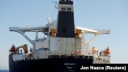 An Iranian flag flies on Iranian oil tanker Adrian Darya 1, previously named Grace 1, as it sits anchored after the Supreme Court of the British territory lifted its detention order, in the Strait of Gibraltar, Spain, August 18, 2019