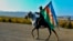 An Azerbaijani soldier with a national flag rides a horse in Ganca, Azerbaijan's second-largest city, near the border with Armenia, on November 10.