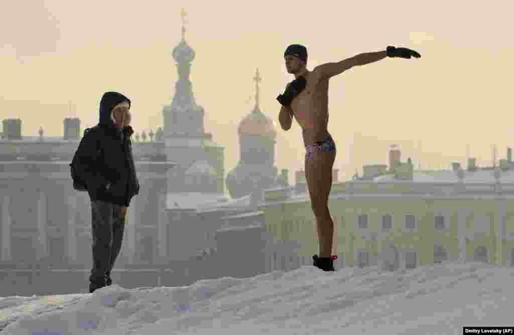 A man warms up prior to swimming in an ice hole in the Neva River in St. Petersburg. (AP/Dmitry Lovetsky)