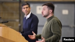 Ukrainian President Volodymyr Zelenskiy (right) and U.K. Prime Minister Rishi Sunak hold a news conference at an army camp in Dorset on February 8. 