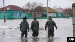 Pripadnici spasilačkih službi Kazahstana evakuišu mještane u poplavljenom mjestu Pokrovka, nedaleko od granice sa Rusijom, 9. april 2024.