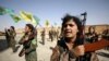 Syrian Democratic Forces (SDF) female fighters hold their weapons during a graduation ceremony in the city of Hasaka, northeastern Syria, August 9, 2017