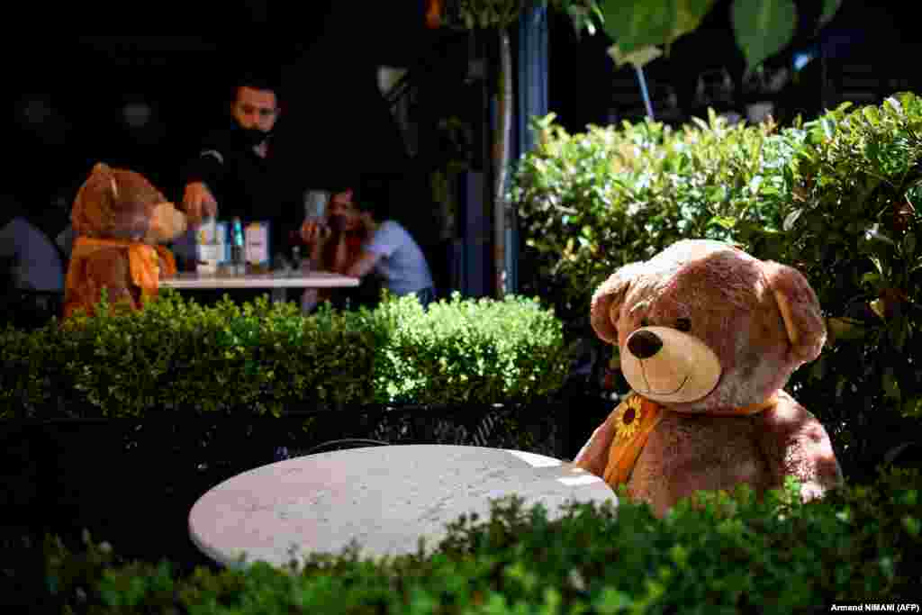 A large teddy bear, used to enforce social distancing, is pictured sitting at a cafe in Pristina as Kosovar authorities announced new measures to fight against a resurgence of the coronavirus. (AFP/Armend Nimani)