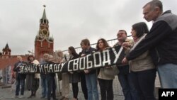 Human rights activist Natalya Gorbanevskaya (4th from left) attends a memorial protest action on Red Square in Moscow on August 25, 2013, with the banner "For your freedom and ours."