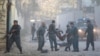 Afghan police carry away a victim after a blast in a diplomatic zone of Kabul on October 31.