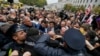 Opposition supporters clash with police in front of the Tbilisi city council during a protest rally in Tbilisi on October 10.