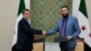 Udhëheqësi i SDF-së, Mazloum Abdi, dhe presidenti i përkohshëm i Sirisë, Ahmed al-Sharaa, pas arritjes së një marrëveshjeje më 10 mars 2025. 