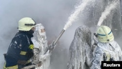 Ukrainian firefighters battle a blaze at a critical energy facility hit by a Russian missile strike in the Ivano-Frankivsk region on December 13,