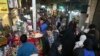 In this Wednesday, March 13, 2019 photo, people shop ahead of the Iranian New Year, or Nowruz, meaning "New Day" at the Tajrish traditional bazaar in northern Tehran, Iran. The holiday, dating back to at least 1700 B.C. and ancient Zoroastrian traditions,