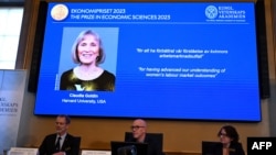 The winner of the 2023 Prize in Economic Sciences in Memory of Alfred Nobel American economist Claudia Goldin is seen on a display as (L-R) the chair of the Committee for the Prize in Economic Sciences in Memory of Alfred Nobel, Jakob Svensson, the Secret