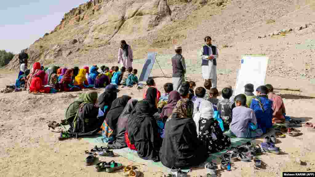 Despite the Taliban&#39;s nationwide ban on teenage girls attending school past the sixth grade, some are resorting to private education while others, such as these students, attend an open-air school in Firozkoh in Afghanistan&#39;s Ghor Province.