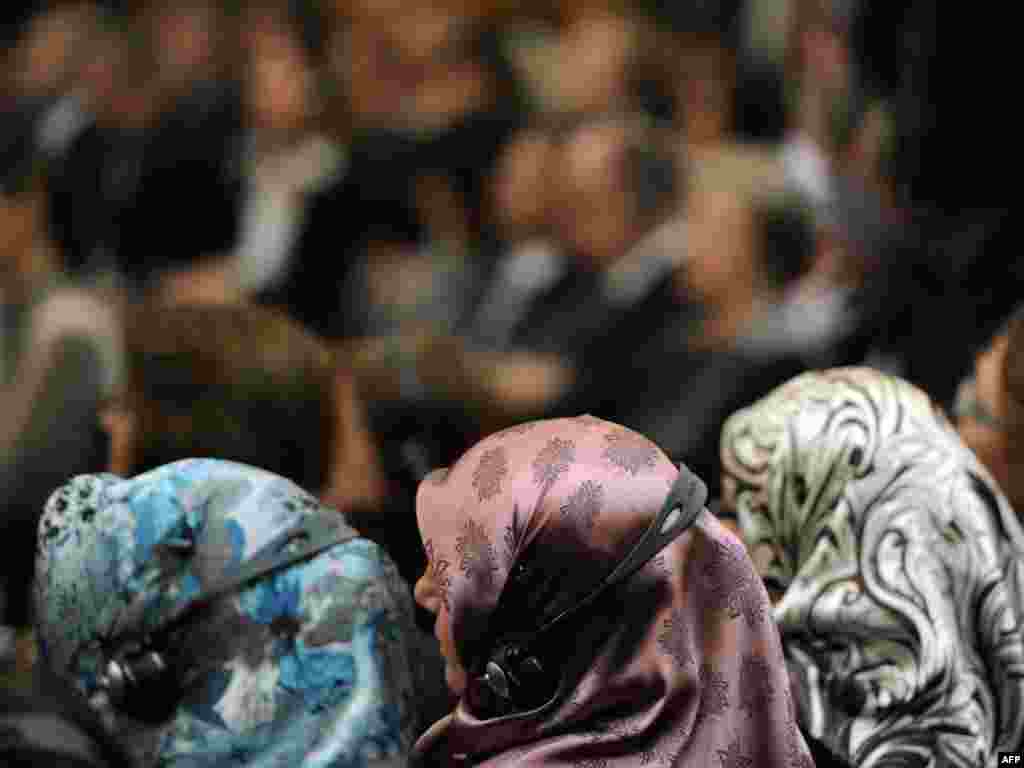 Women wearing head scarves attend a ceremony in Berlin to celebrate 50 years of Turkish guest workers in Germany. (Odd Andersen for AFP) 