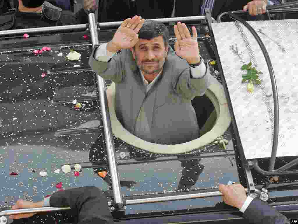 Iran's President Mahmud Ahmadinejad salutes the crowd as he crosses Beirut airport highway on his first visit to the east Mediterranean country on October 13. The hard-line leader arrived in Beirut on October 13 for a controversial two-day visit, the highlight of which was a tour of Lebanon's volatile border with his arch-enemy Israel. Photo by AFP