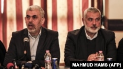 PALESTINE -- Yahya Sinwar (L), leader of the Islamist Hamas movement in the Gaza Strip, and the movement's political bureau head Ismail Haniyeh meet with the heads of families in Gaza City on December 26, 2017, to discuss recent developments on the reconc