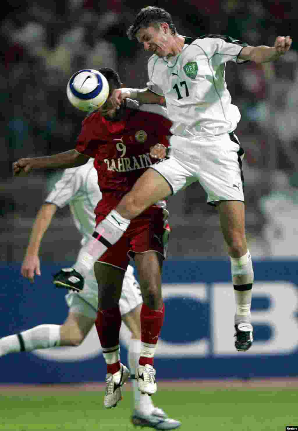 Uzbekistan's Alexey Nikolaev (in white) leaps for the the ball during a World Cup playoff match against Bahrain in October 2005.Uzbekistan has attempted to reach the World Cup five times since gaining its independence from the USSR, sometimes coming agonizingly close. Its most controversial near miss came in 2005, when a refereeing error in the first leg of the playoff against Bahrain led FIFA to order a replay. Bahrain ultimately advanced on away goals.