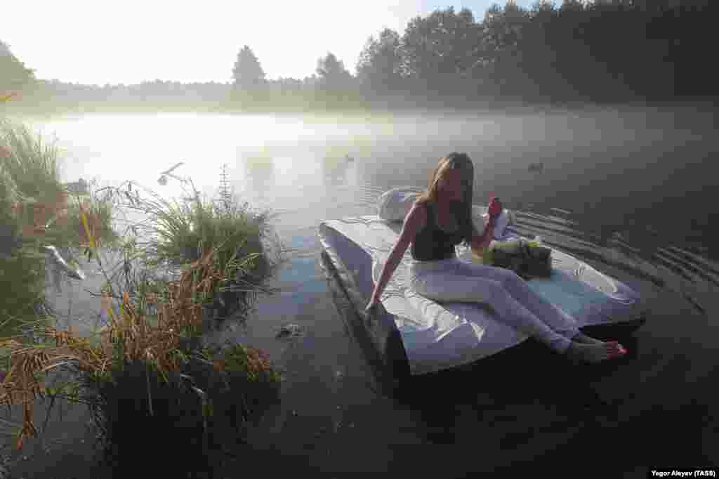 A girl poses for a photo on the Big Blue Lake in the Russian republic of Tatarstan. (TASS/Yegor Aleyev)