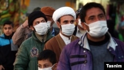 Residents of Qom, the epicenter of the coronavirus outbreak in Iran, wait to be examined by a mobile medical team on February 27.