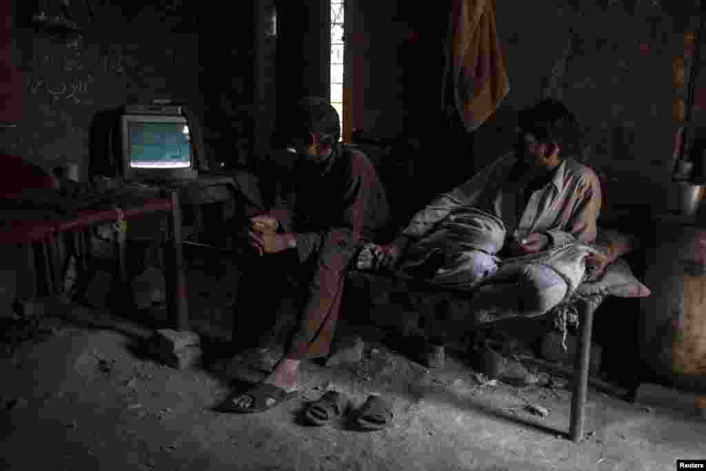 Miners watch television during a break.