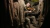 UKRAINE -- A Ukrainian service man plays the violin in the dugout of a position on the frontline with Russia-backed separatists, not far from Gorlivka, in the Donetsk region, on December 22, 2020. 