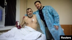 President Volodymyr Zelenskiy poses for a picture with an injured Ukrainian soldier as he visited a hospital in the Kharkiv region on March 22.