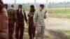 Iranian Revolutionary Guard Commander Qassem Soleimani (R) uses a walkie-talkie at the frontline during offensive operations against Islamic State militants in the town of Tal Ksaiba in Salahuddin province, March 8, 2015. File photo