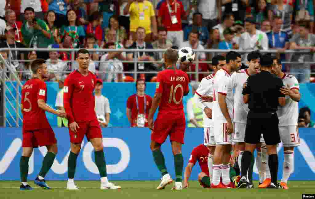 Soccer Football - World Cup - Group B - Iran vs Portugal - Mordovia Arena, Saransk, Russia - June 25, 2018 Iran players remonstrate with referee Enrique Caceres as Portugal's Cristiano Ronaldo and team mates react REUTERS/Murad Sezer