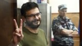 RUSSIA – Russian opposition politician Ilya Yashin, detained on suspicion of spreading false information about Russia's army, stands inside a defendants' cage during a court hearing in Moscow, July 13, 2022