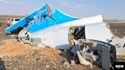 Debris from the crashed Russian jet lies strewn across the sand at the site of the crash in the Sinai.