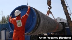 A worker puts a cap on a pipe at a construction site for the Nord Stream 2 gas pipeline in the Leningrad region earlier this year. 