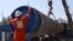 A worker puts a cap on a pipe at a construction site for the Nord Stream 2 gas pipeline in the Leningrad region earlier this year. 
