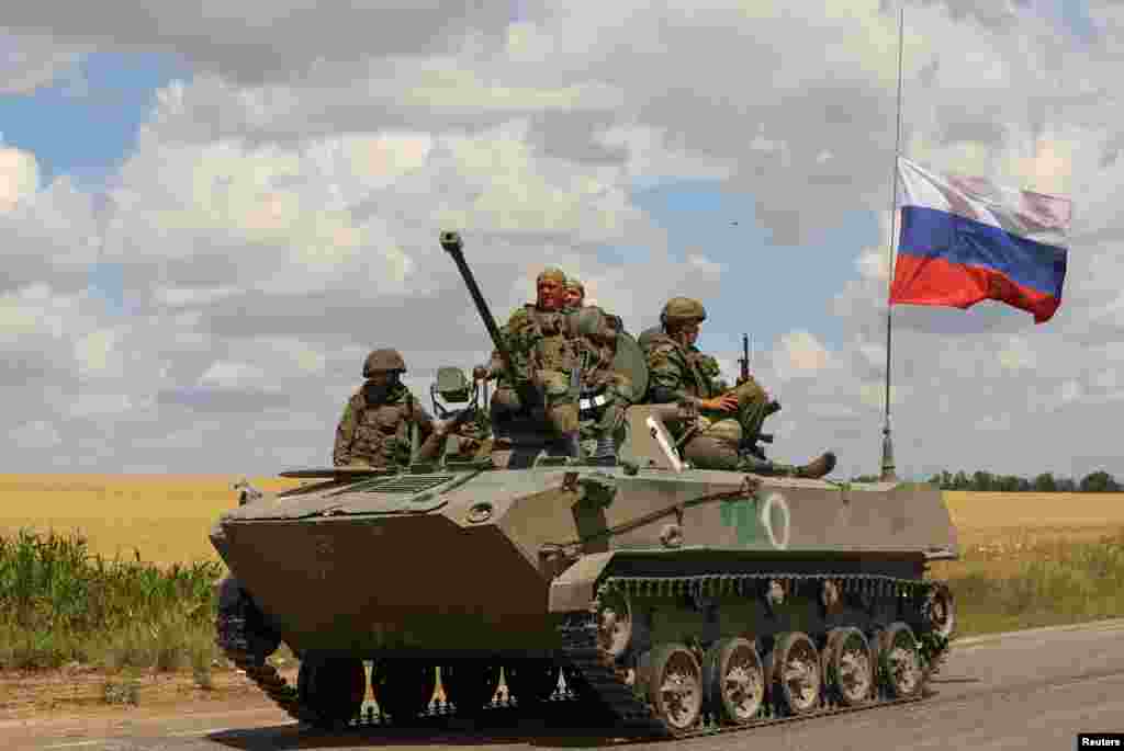 Russian troops ride on an armored personnel carrier in Ukraine&#39;s Zaporizhzhya region.