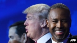 Republican Presidential hopefuls Marco Rubio (left), Donald Trump (center), and Ben Carson look on during a break in a Republican presidential debate in Boulder, Colorado.