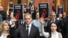 Opposition deputies hold signs reading "You have blood on your hands" during a session of the Serbian parliament in Belgrade on November 25.