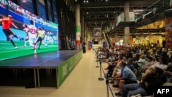 Iranian soccer fans watch broadcast of the 2026 World Cup match between Belgium and Iran in Tehran on June 21.
