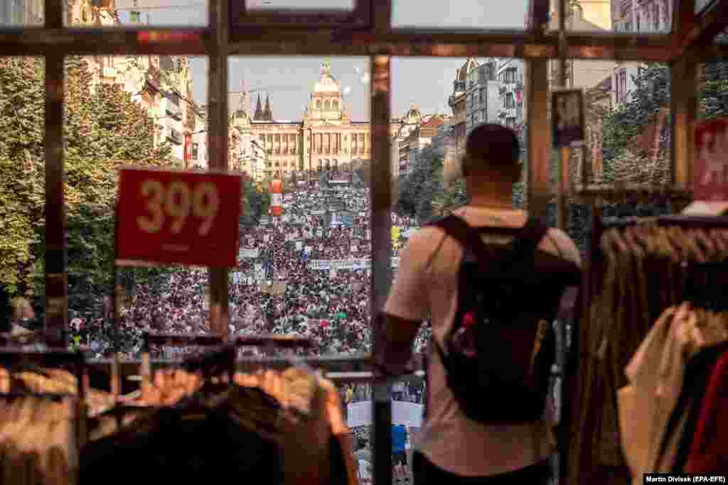 A man looks out from a store window in central Prague as tens of thousands of demonstrators gather to protest against Czech Prime Minister Andrej Babis on June 4. (epa-EFE/Martin Divisek)