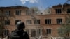A Ukrainian serviceman surveys the aftermath of a Russian air strike on a hospital in Kharkiv on July 25.