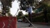 A Pakistani security official stands guard outside a residential area of Islamabad sealed off as part of the new smart lockdown after increasing numbers of coronavirus infections were reported.