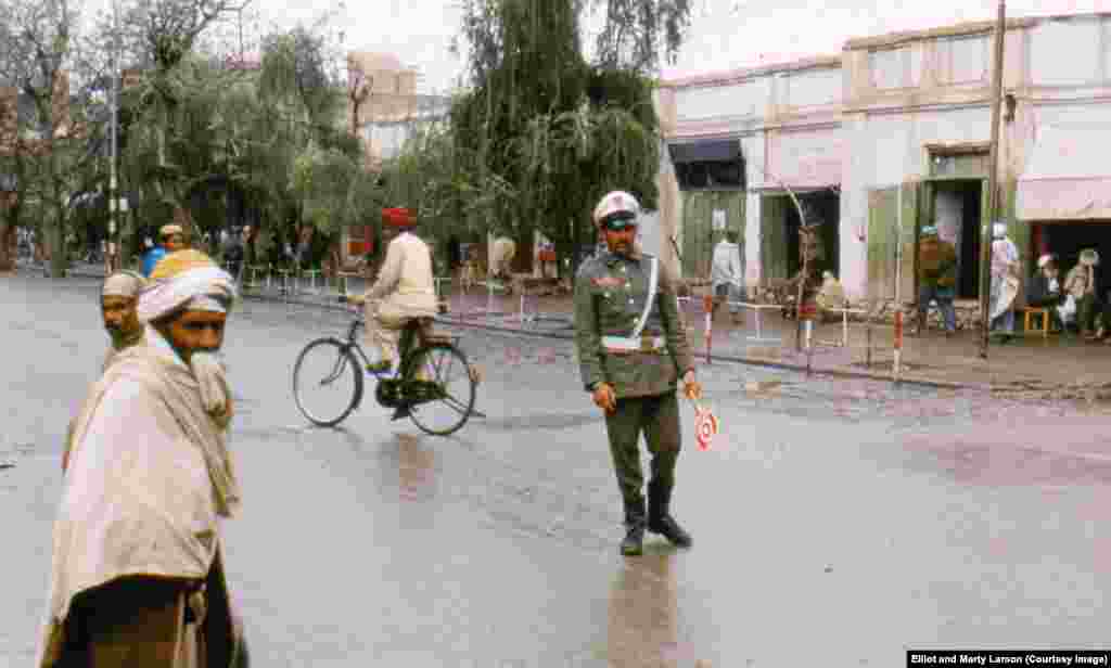 A traffic policeman after a&nbsp;rainfall in Jalalabad. When Elliot last saw Afghanistan, in 2011, he felt that despite the change in the security situation the country was much the same. &quot;The way Afghans describe things is, &#39;new saddle, same donkey,&#39;&quot; Elliot says.