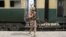 A Pakistan Army soldier stands guard next to a rescue train at the railway station in Mushkaf, Balochistan, on March 12 after an attack by separatist militants the day before. 