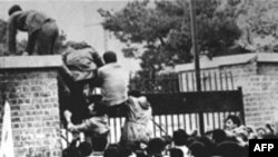 Iranian students climb over the wall of the U.S. Embassy in Tehran in November 1979.