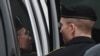 U.S. -- Army Pfc. Bradley Manning (L) is escorted into court in Fort Meade, Maryland, July 25, 2013