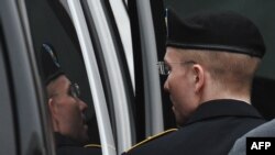 U.S. -- Army Pfc. Bradley Manning (L) is escorted into court in Fort Meade, Maryland, July 25, 2013