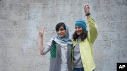 Iranian journalists Niloufar Hamedi (right) and Elaheh Mohammadi, shown after their release on bail on January 14, pending their appeals.