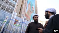 Clerics stand next to a model missile and a nuclear enrichment centrifuge during a rally outside the former US embassy in Tehran as Iranians mark the 46th anniversary of the start of the Iran hostage crisis, on November 4